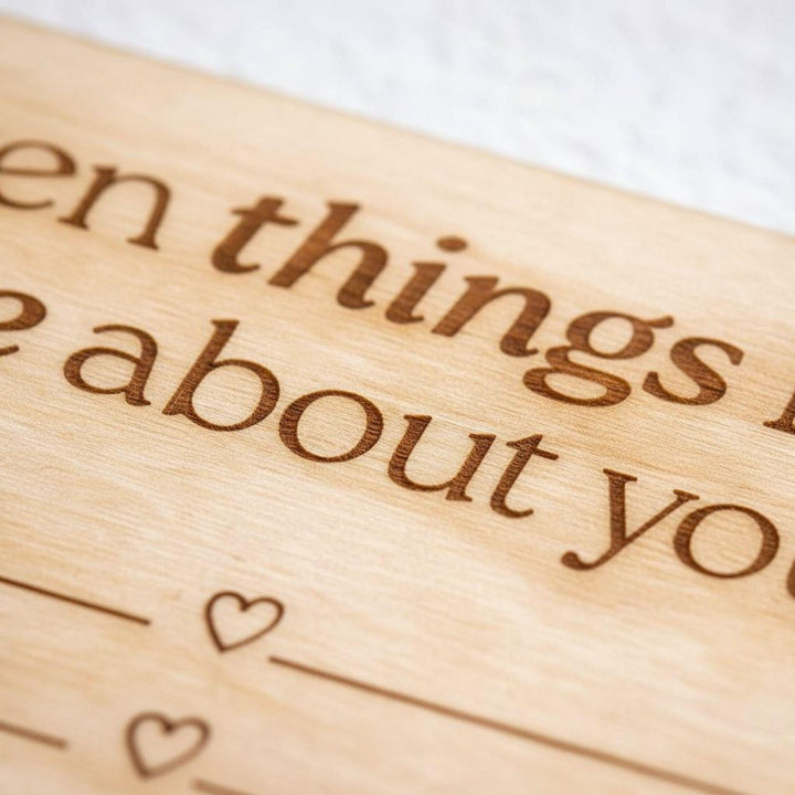 Close-up of engraved wooden love note text: &