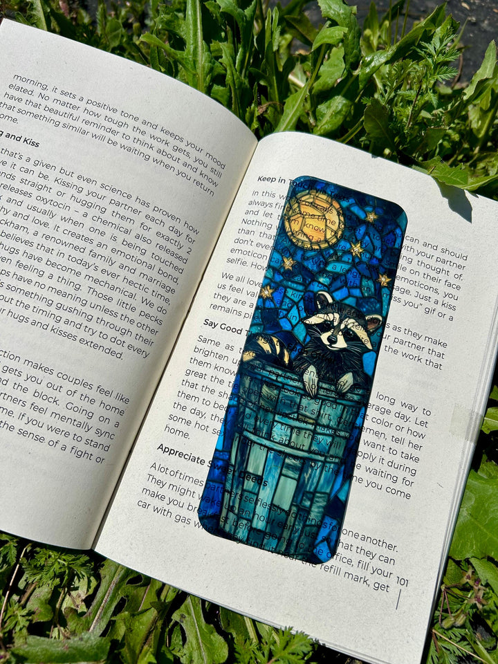 Blue raccoon bookmark with archway design and circular moon motif