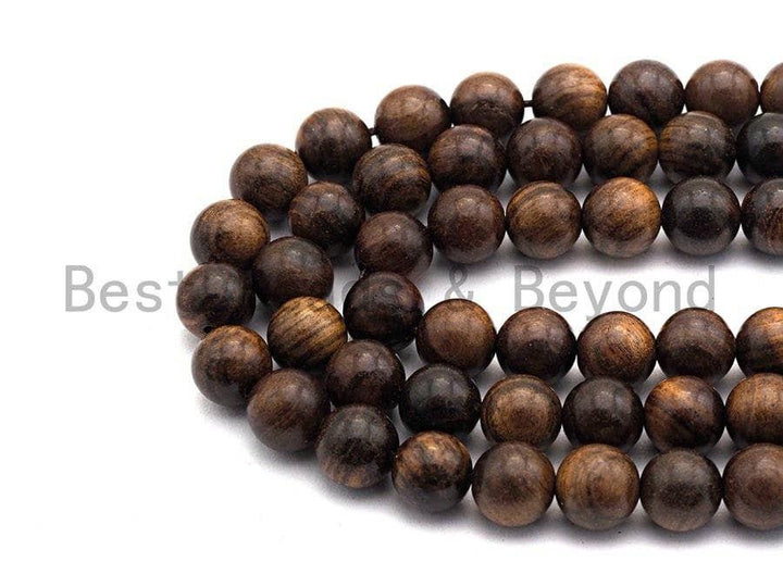 Close-up of natural brown round wood beads with dark and light wood grain