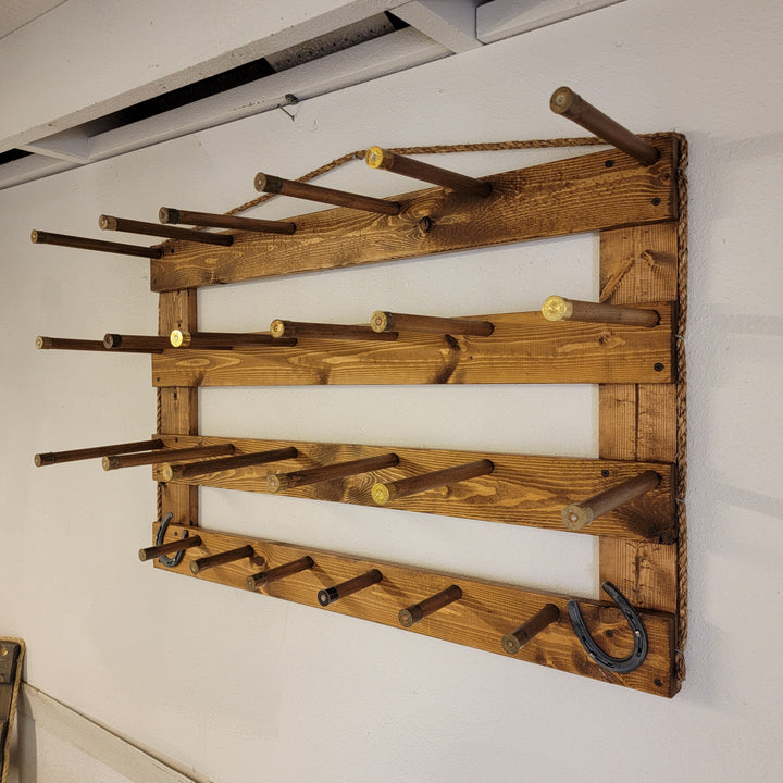 Wooden wall hat organizer with multiple wooden pegs and hanging wire loop
