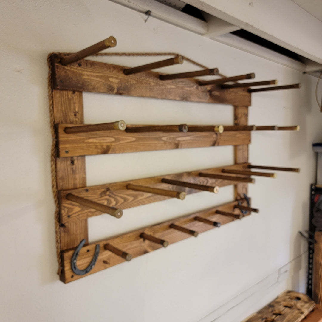 Close view of wooden wall hat organizer with several peg pegs and long brim holders