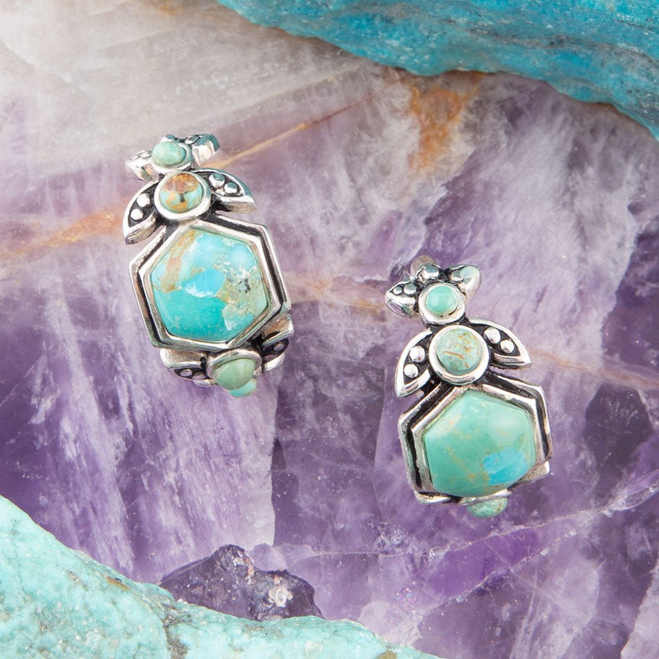 Pair of turquoise hoop earrings with octagonal center and floral silver details