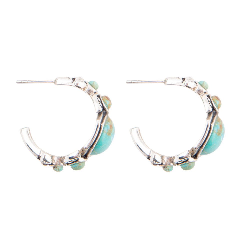 Sterling silver turquoise hoop earrings with small bezel stones along the outer edge