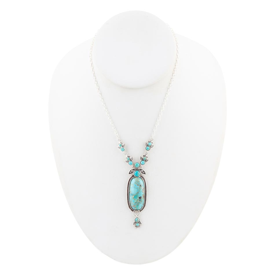 Sterling silver oval blue turquoise pendant with small round turquoise stones along the chain