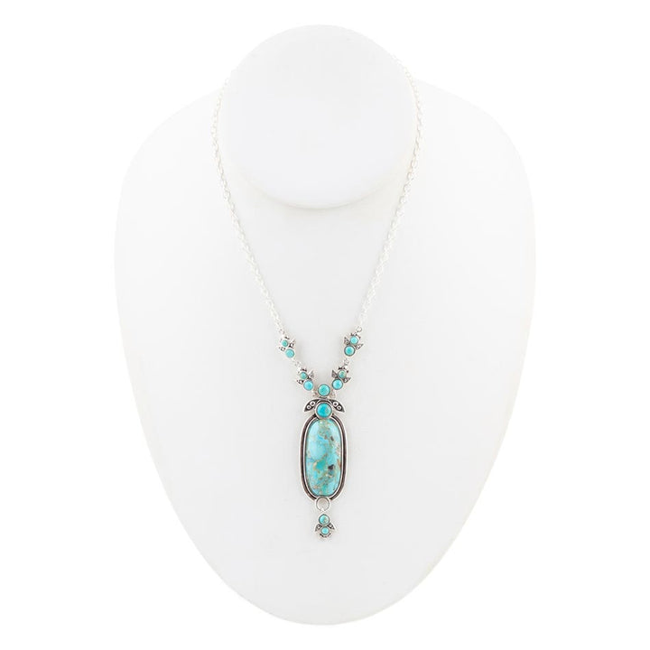 Sterling silver oval blue turquoise pendant with small round turquoise stones along the chain