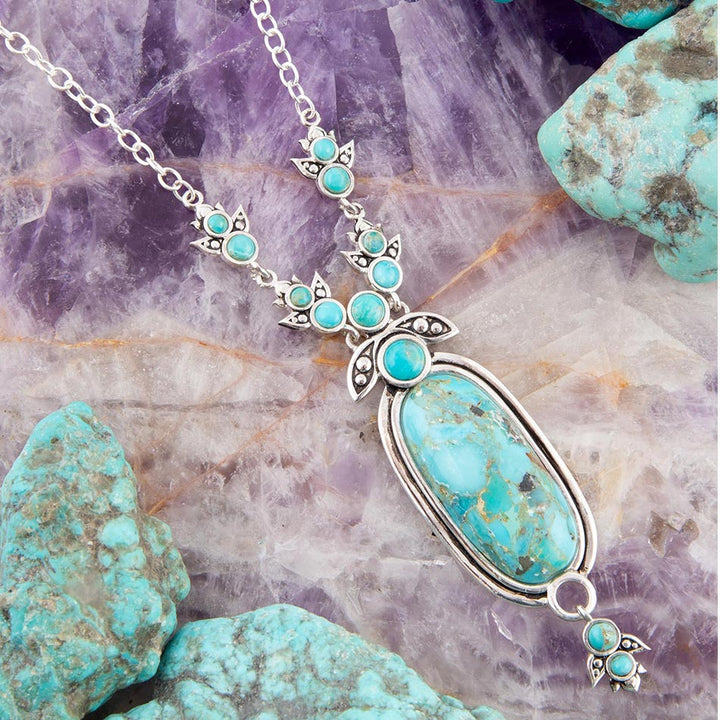 Sterling silver pendant necklace featuring an oval blue turquoise charm with turquoise bezel details