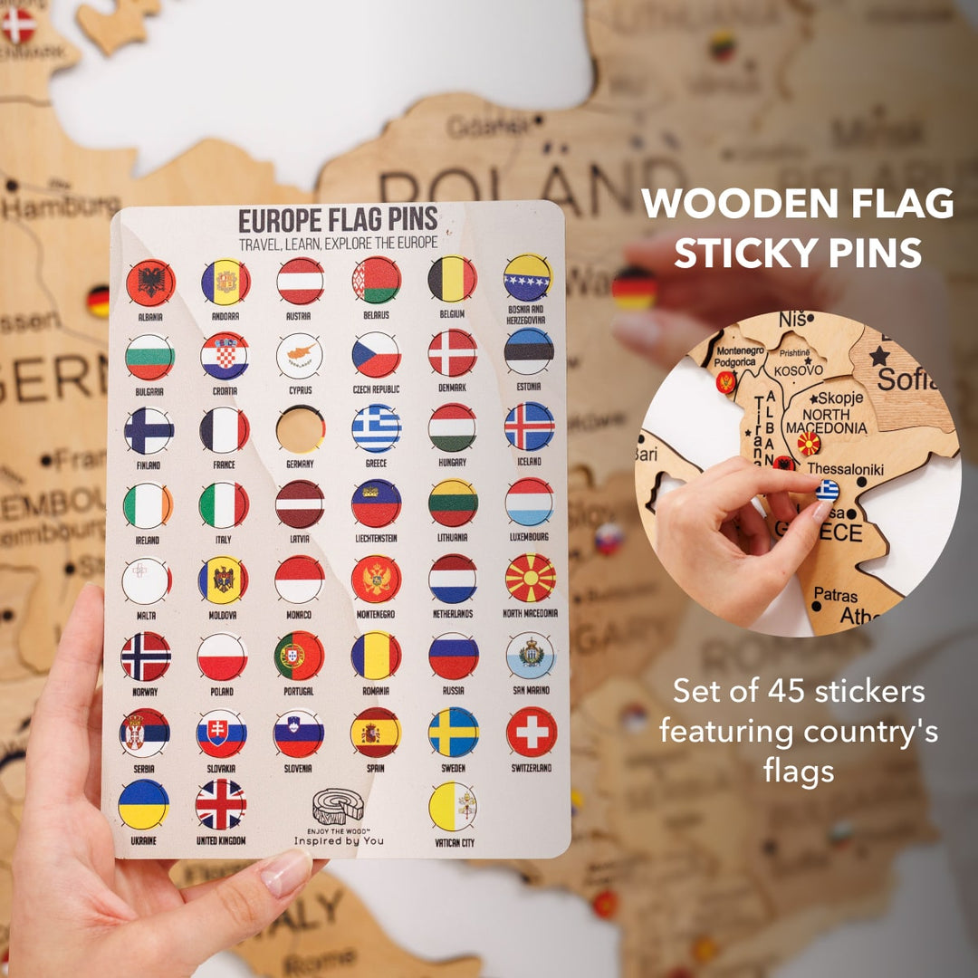 Wooden flag sticky pins set with country-flag stickers; hand places a pin