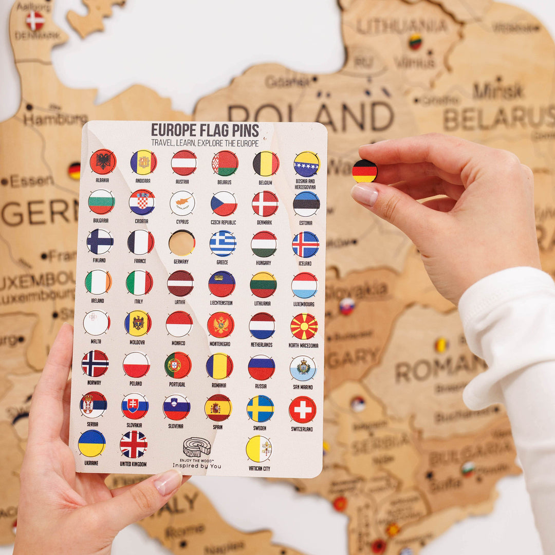 European flag pins card with circular flag designs; hand holds a pin