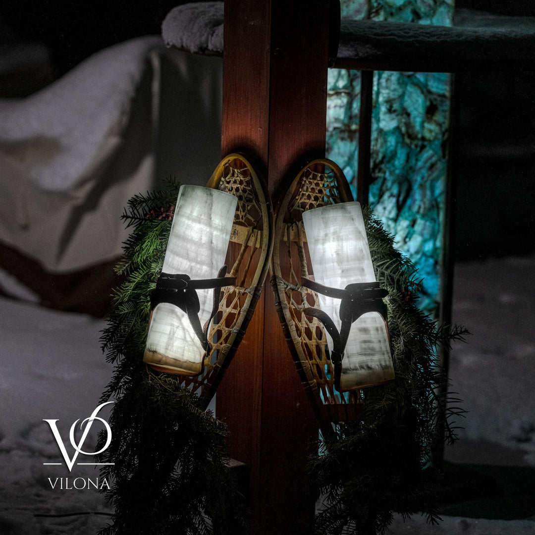 Dual lantern-style candle wall decoration with black straps, frosted shades, and pine