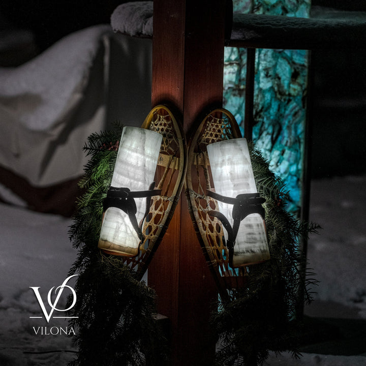 Dual lantern-style candle wall decoration with black straps, frosted shades, and pine