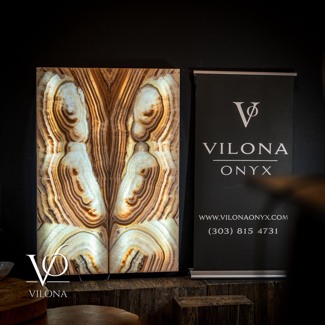 Pair of Sahara onyx wall panels with cream and tan oval insets and vertical striated pattern.