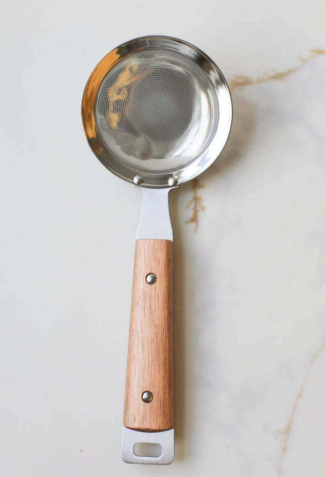 Round mesh strainer with silver mesh screen and light wood handle, hanging loop