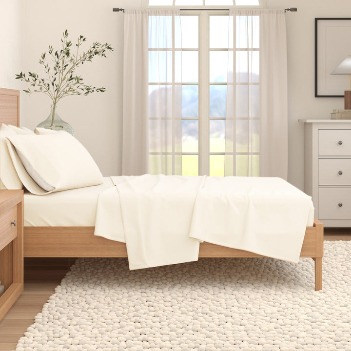 Cotton flannel sheet set in off-white on bed with pillowcases