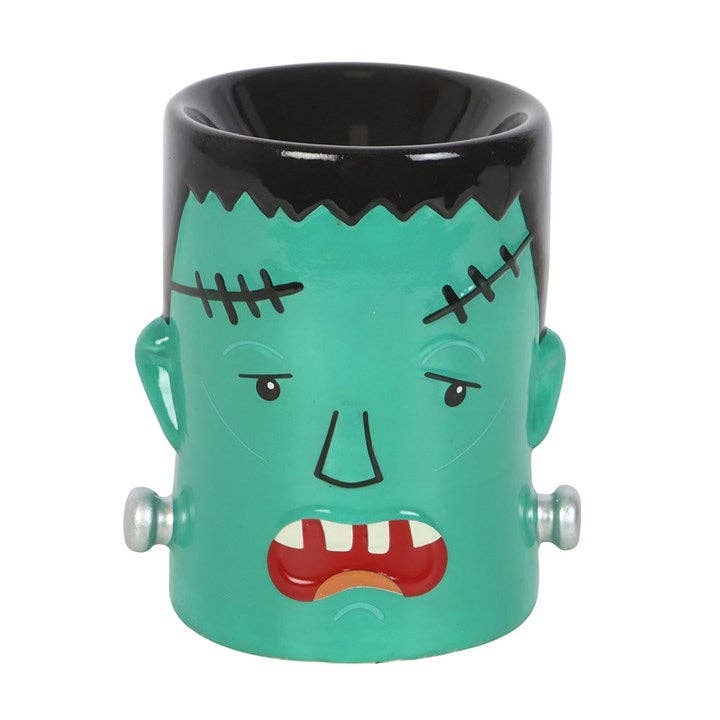 Halloween monster wax warmer, teal ceramic cylinder with black rim and stitched mouth.