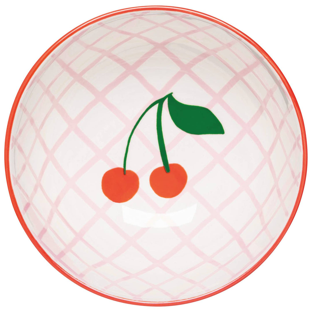 Pink plaid cherry bowl with orange cherries and green leaf motif on white surface