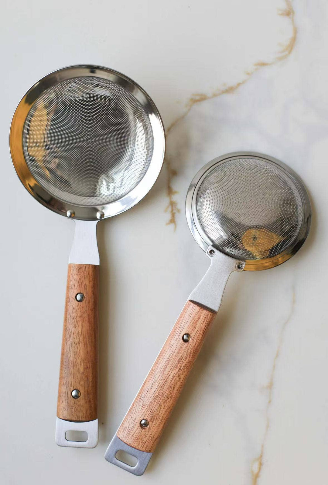 Two round mesh strainers with silver mesh screens and wood handles, large and small