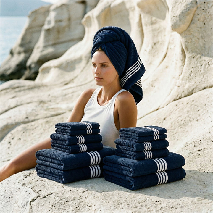 Folded navy cotton towels stacked with white stripe borders