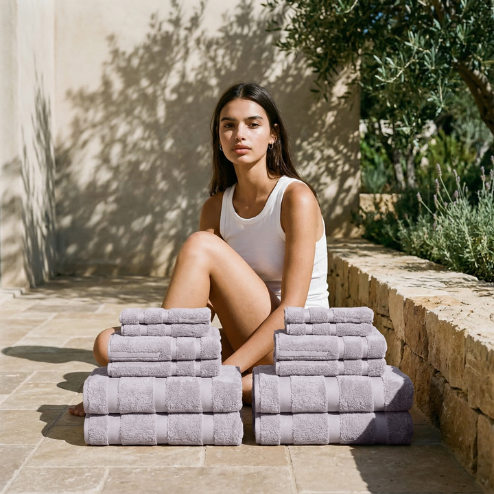 Lavender cotton towels folded in stacks on a patio setting