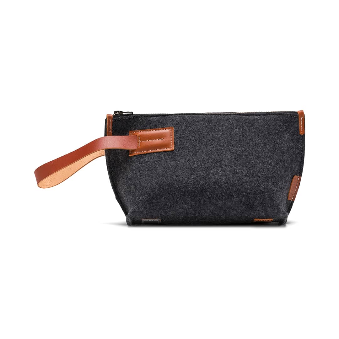 Charcoal felt travel kit pouch with tan leather handle and rounded front