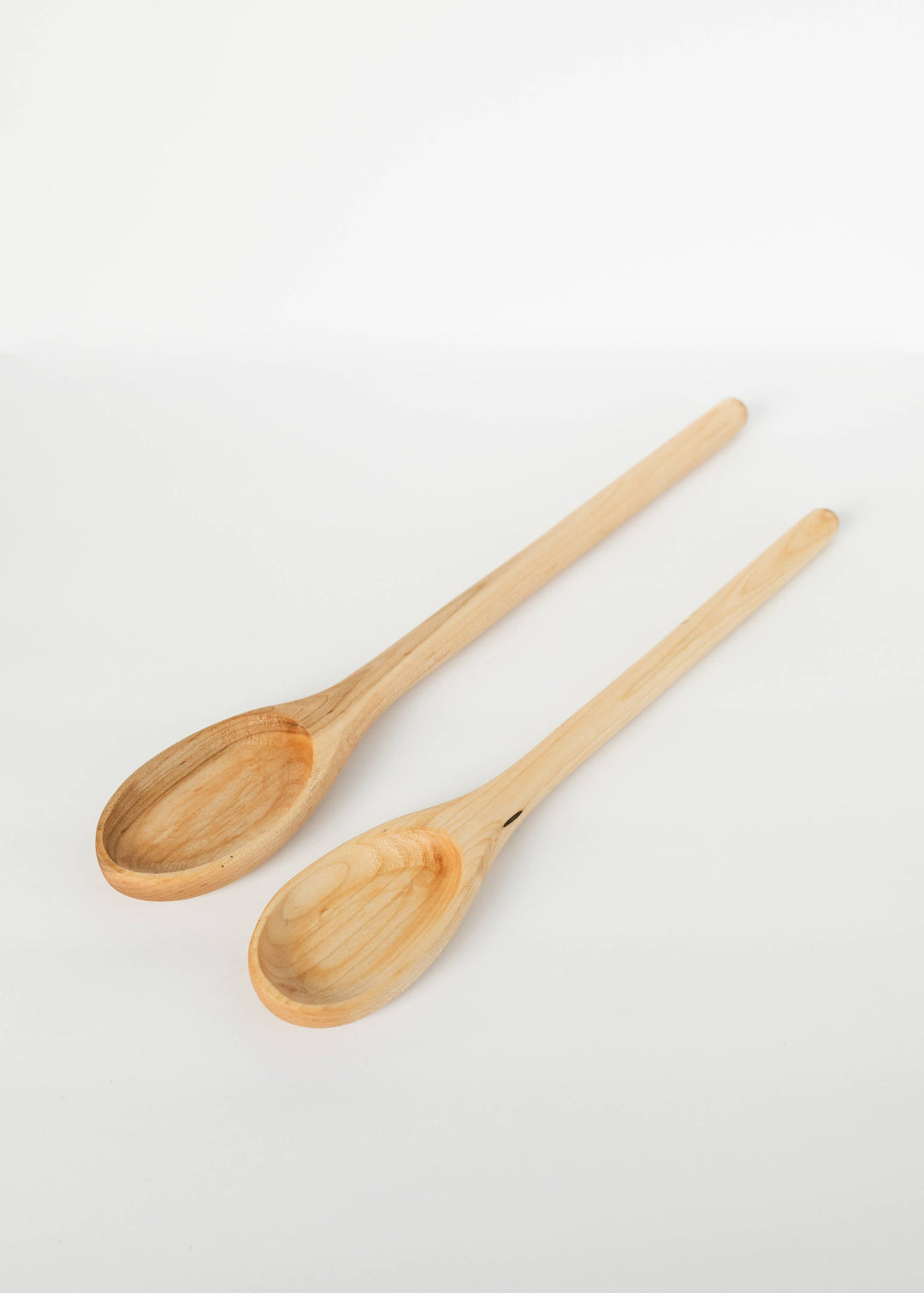 Wooden spoons set, two light-wood oval bowls with long handles
