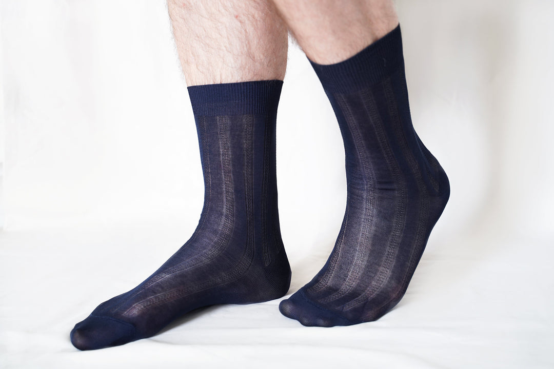 Men's dress socks on feet, dark navy with vertical stripe pattern, crew length