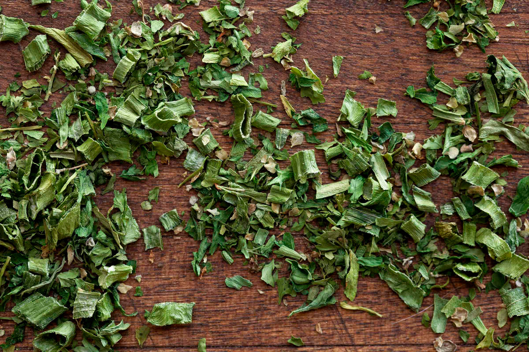 Fines Herbes herb blend leaves and flakes on a wooden surface