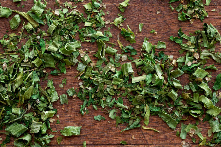 Fines Herbes herb blend leaves and flakes on a wooden surface