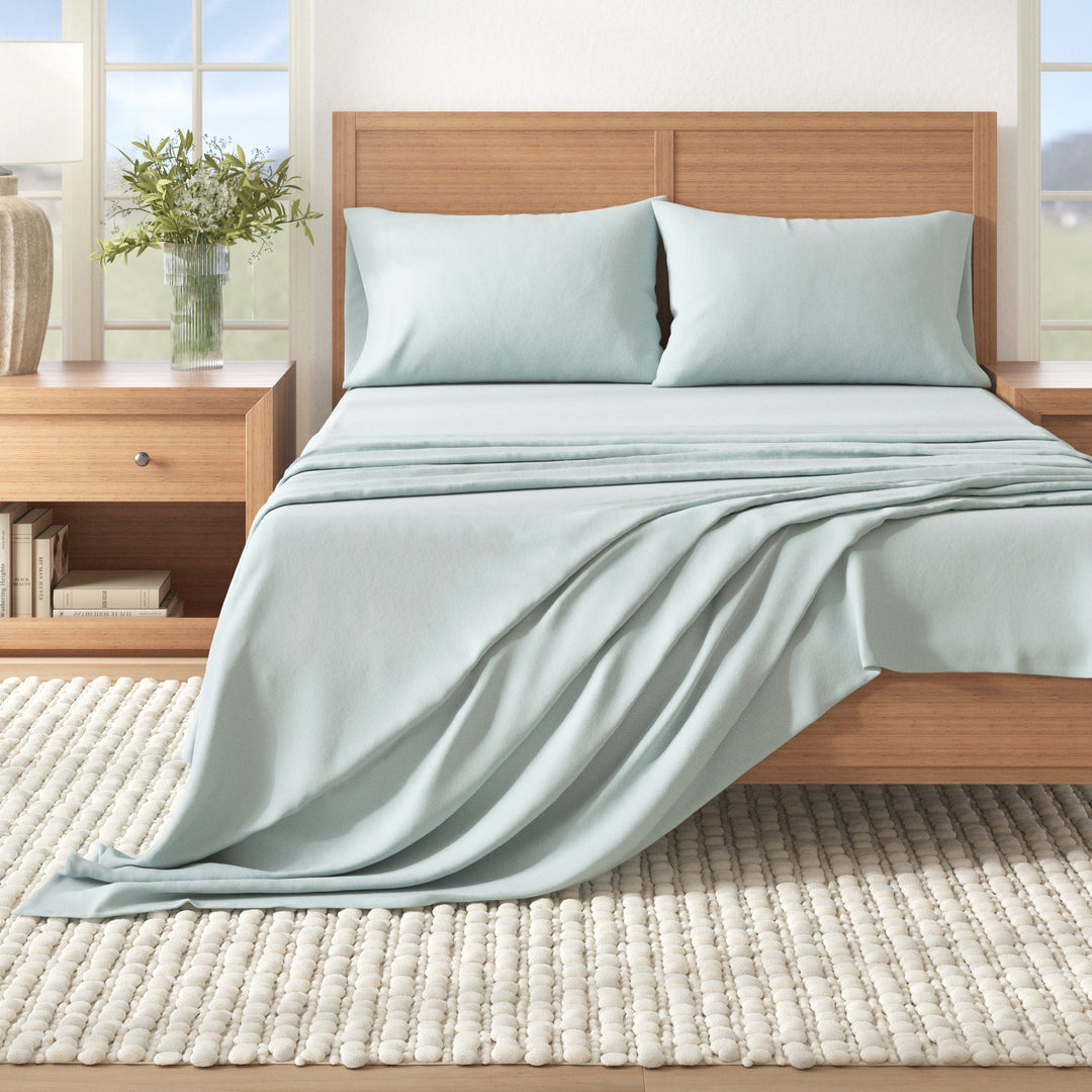 Light blue cotton flannel sheet set on bed with matching pillowcases