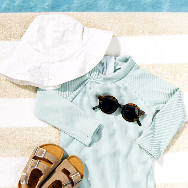 Mint ribbed long-sleeve swimsuit romper with snap front, short sleeves and legs