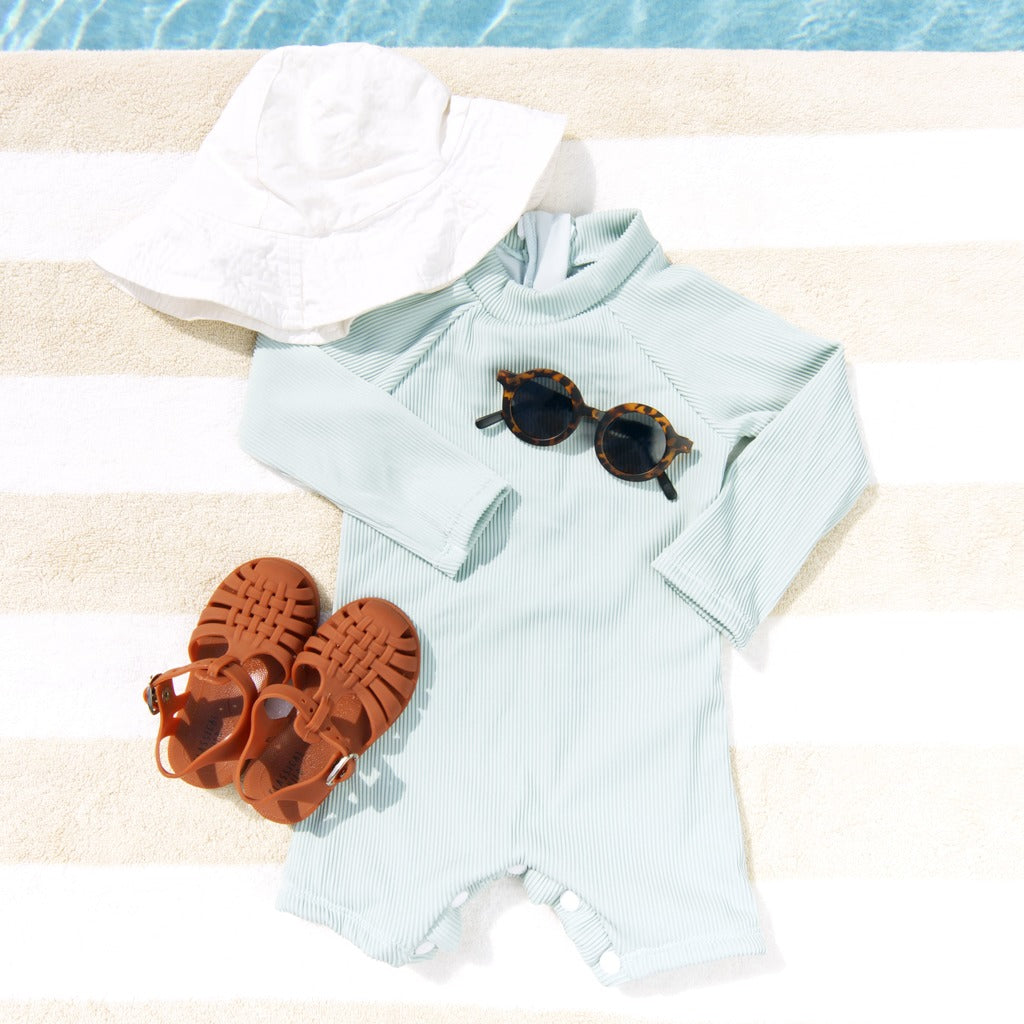 Mint ribbed long-sleeve swim romper with snap front and elastic shorts legs