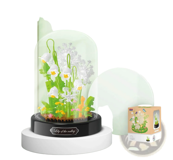 Clear glass dome with white and green building block flowers and orange accents