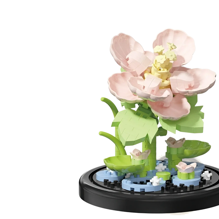 Light pink flower building blocks with green leaves on a round black base