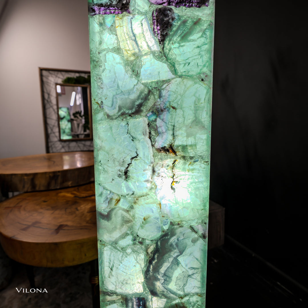Close view of glowing green fluorite square prism lamp with crackle-like stone pattern