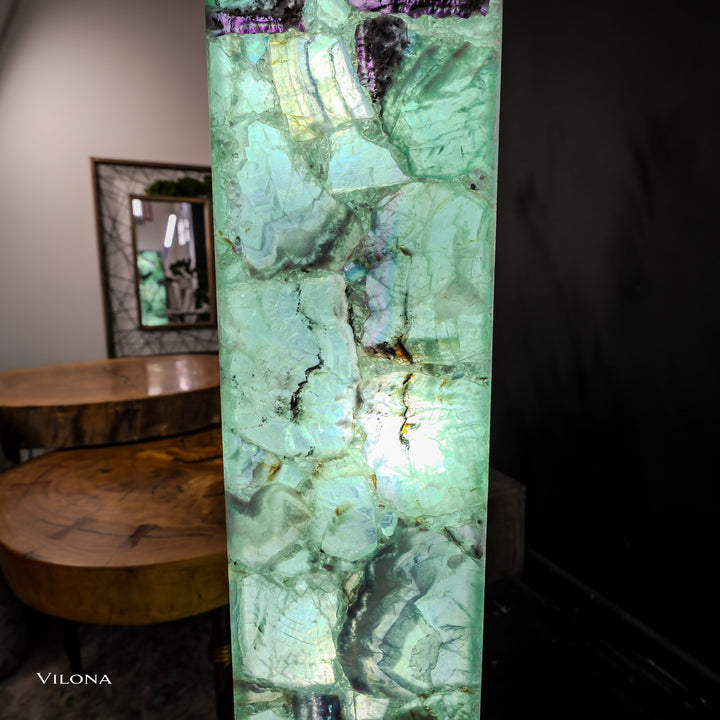 Close view of glowing green fluorite square prism lamp with crackle-like stone pattern