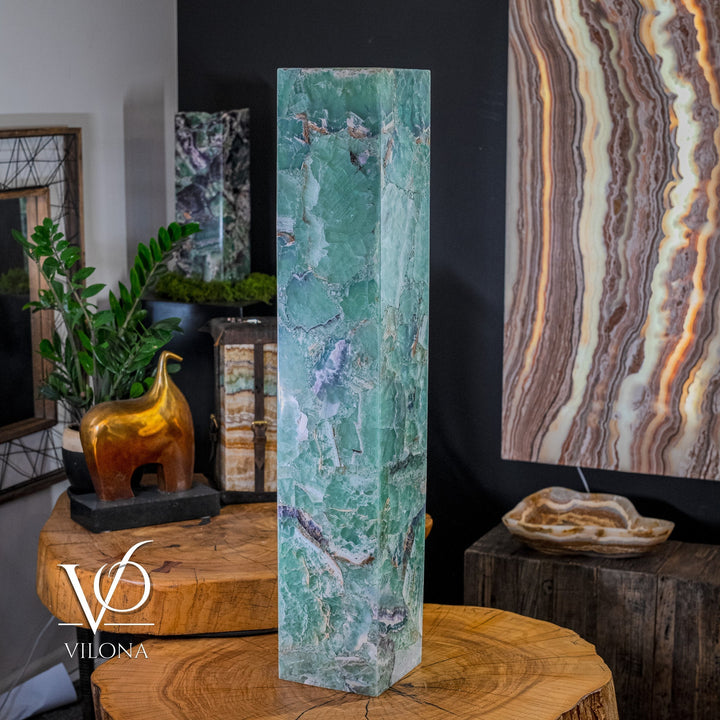 Tall turquoise square fluorite floor lamp on round wooden surface