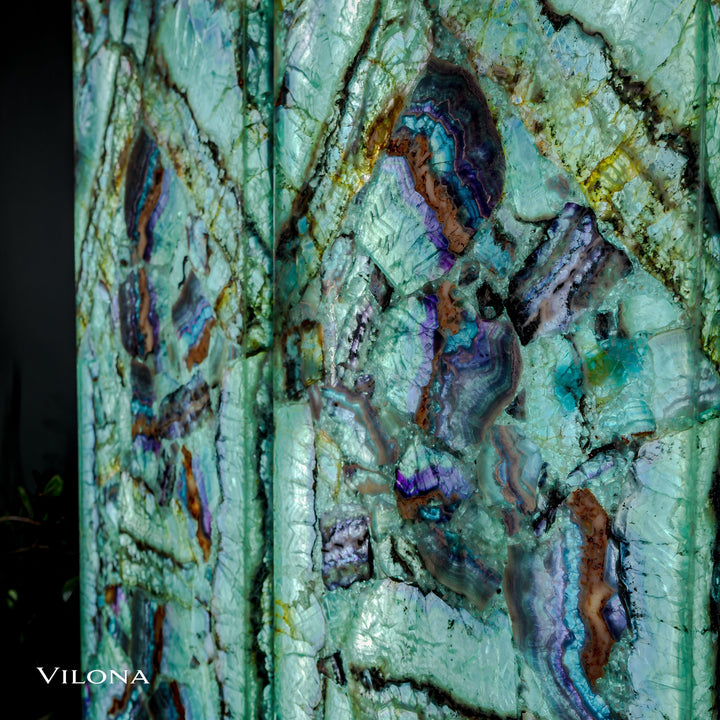 Fluorite wall panel close-up, teal stone with purple-blue veins and brown patches