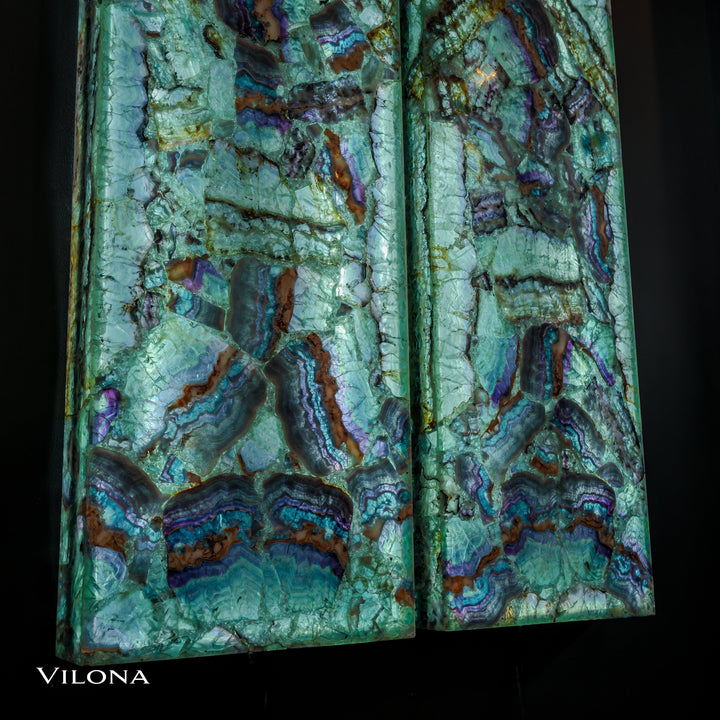 Two fluorite crystal wall panels, teal stone with deep purple and brown streaks