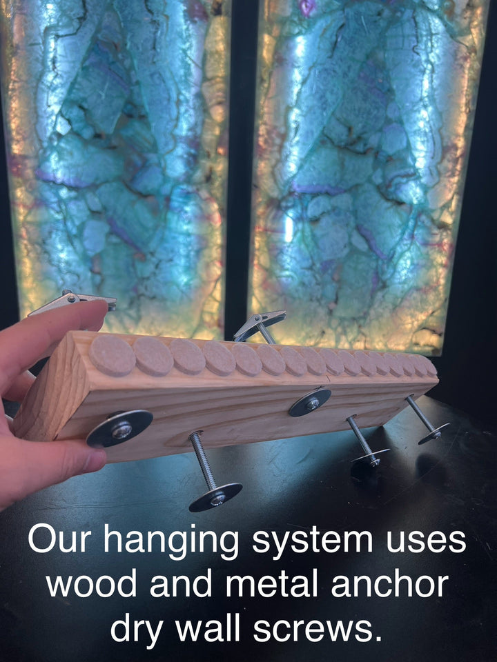 Fluorite crystal wall panel mounting held by hand with wood rail and metal anchors