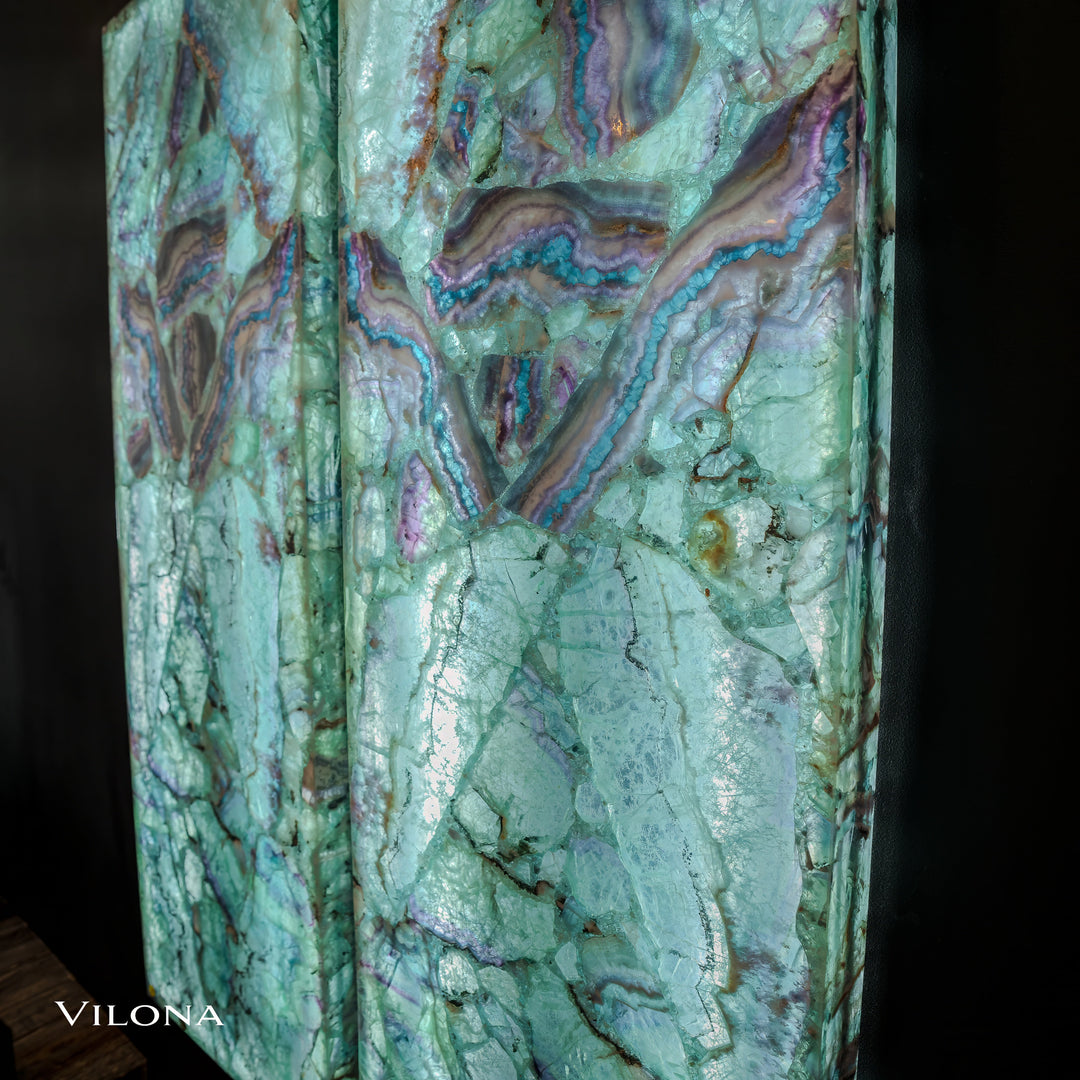 Fluorite crystal wall panel in light teal with purple and gold marbling