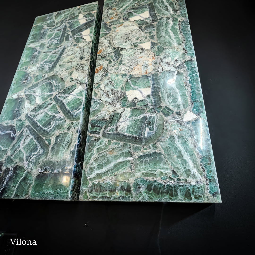 Fluorite wall panel pair with light green-blue striations and scattered stone specks