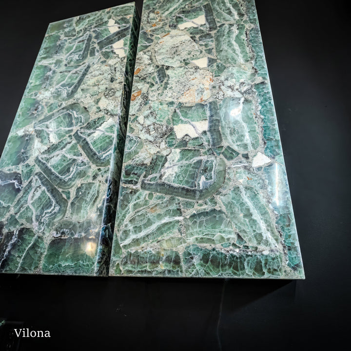 Fluorite wall panel pair with light green-blue striations and scattered stone specks