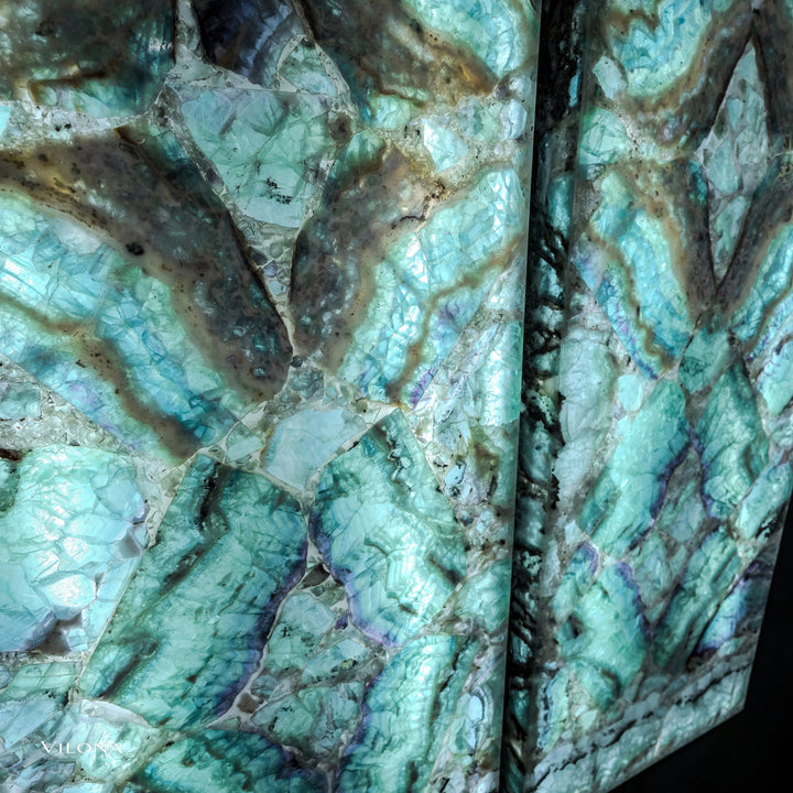 Teal fluorite wall panels detail: faceted stone facets, specks, and dark vein patterns.