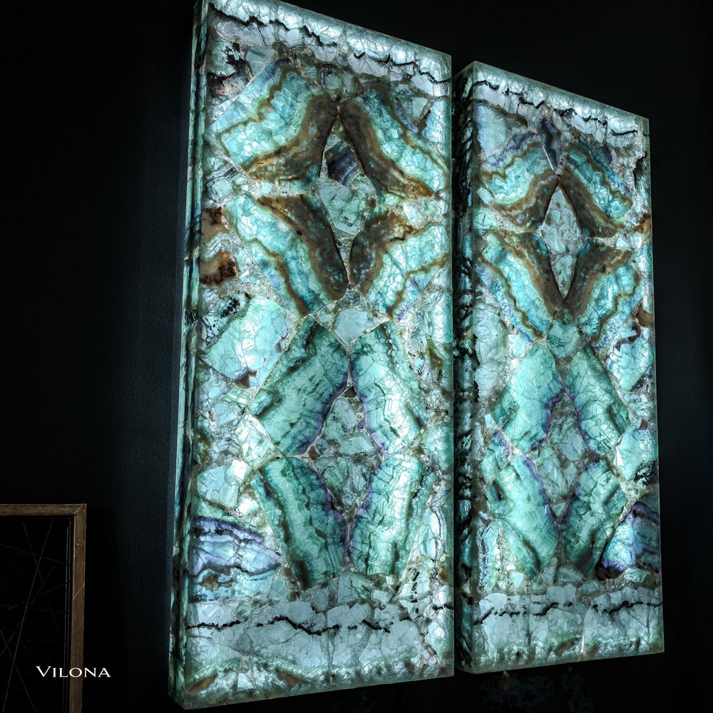 Pair of teal fluorite wall panels with symmetrical faceted star shapes and dark veining.
