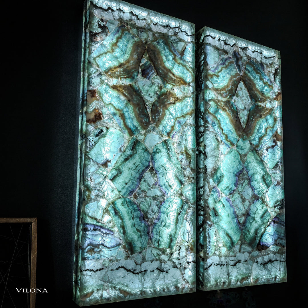 Pair of teal fluorite wall panels with symmetrical faceted star shapes and dark veining.