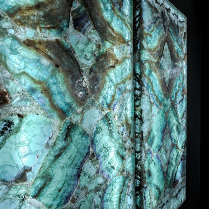 Close-up of two teal fluorite wall panels showing dark veins and reflective crystal facets.