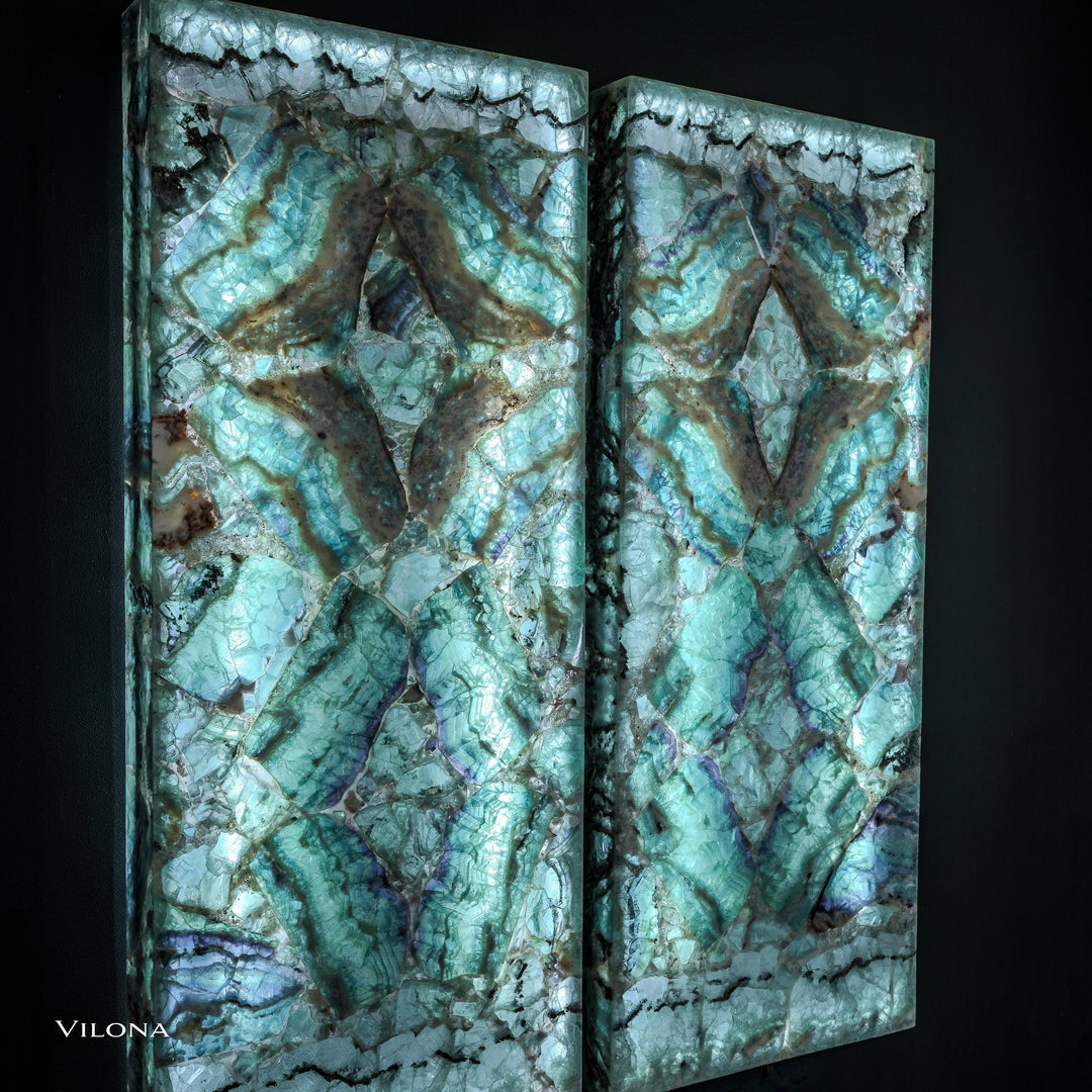 Two teal fluorite wall panels with symmetrical star motif and varied aqua, green, and dark tones.