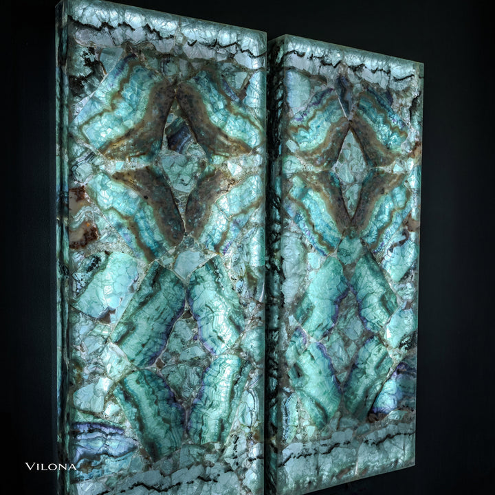 Two teal fluorite wall panels with symmetrical star motif and varied aqua, green, and dark tones.