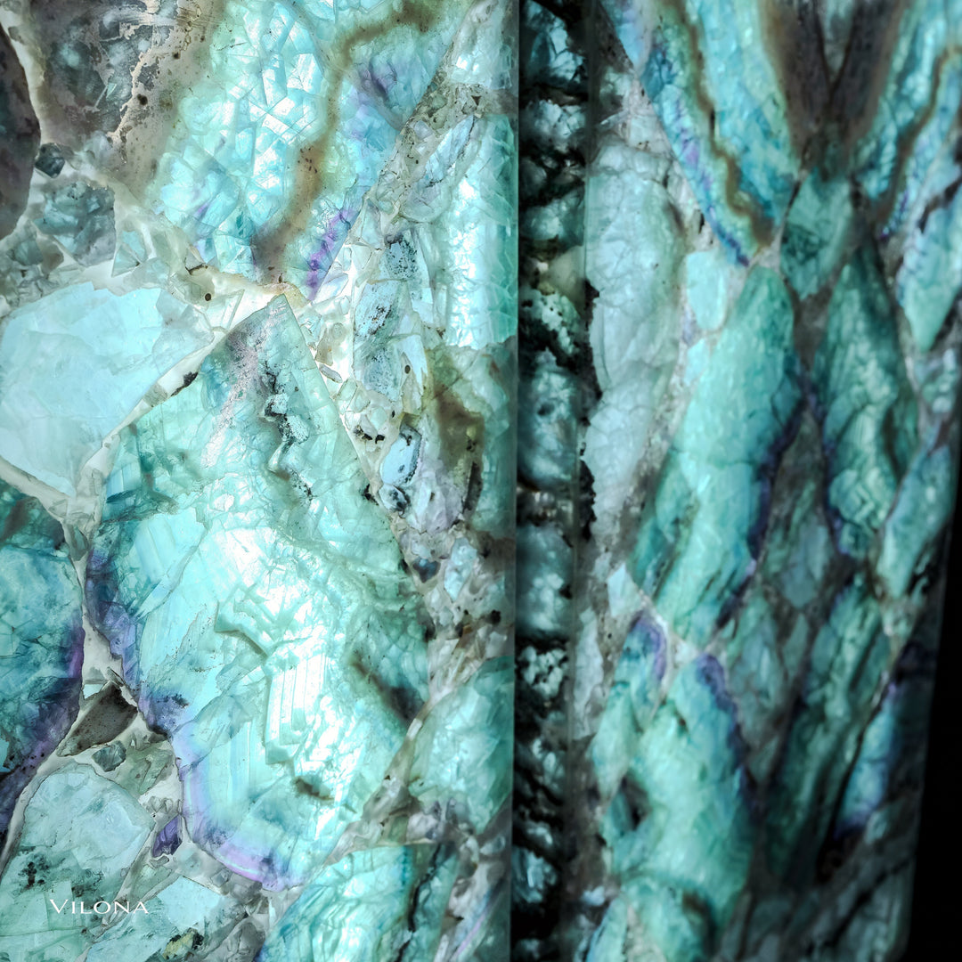 Side-by-side close-up of teal fluorite wall panels with star shapes and sparkling crystal facets.