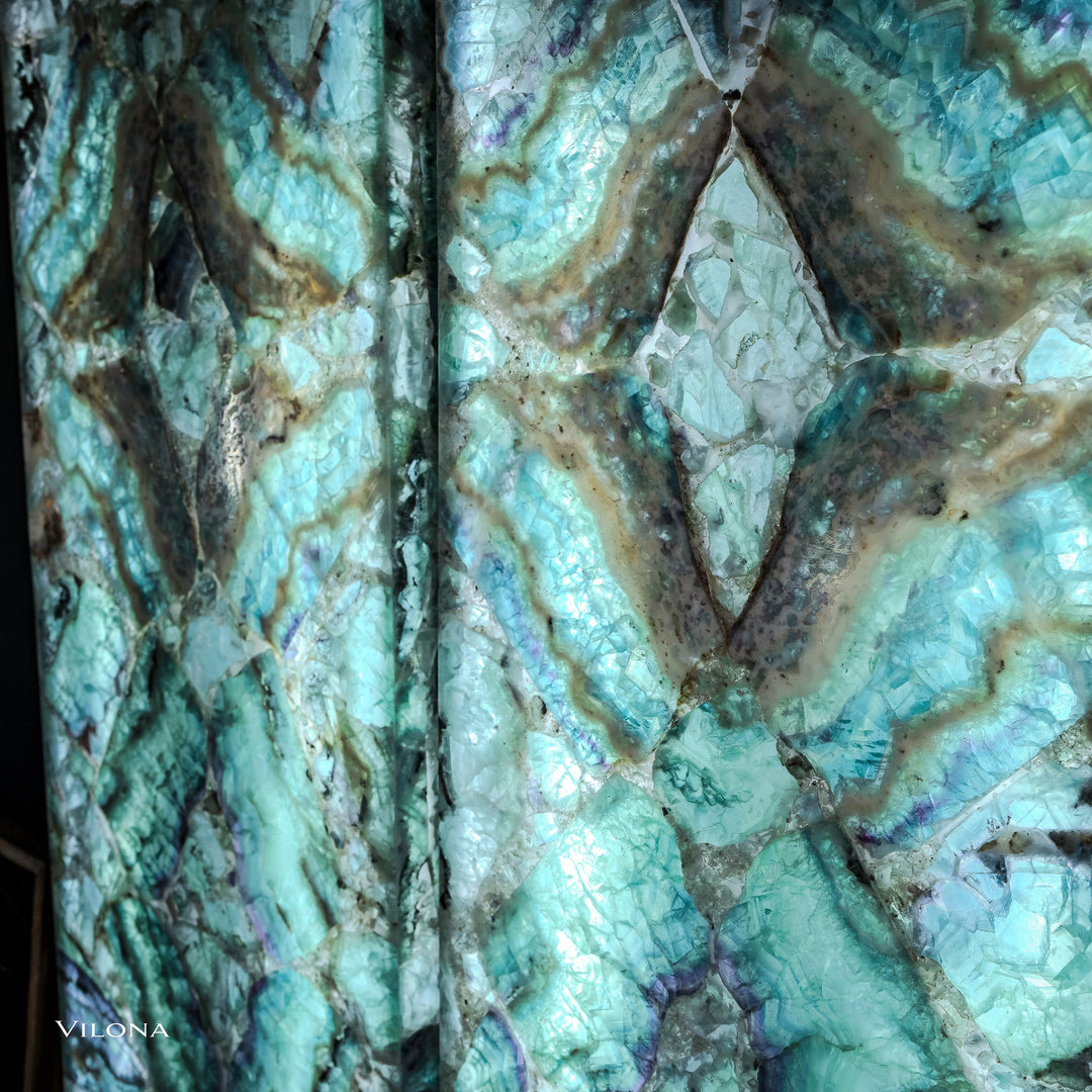 Two teal fluorite wall panels, front view: star motif with swirling veins and dark accents.