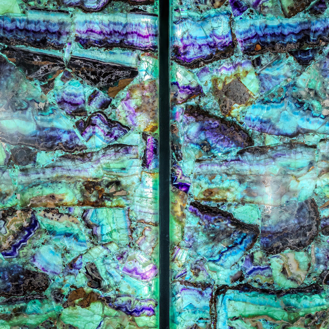 Fluorite crystal wall panels close-up showing turquoise, violet, and green facets with black inclusions